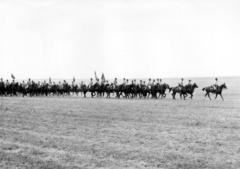 United States cavalry riding in an extended formation at Fort Riley in 1941