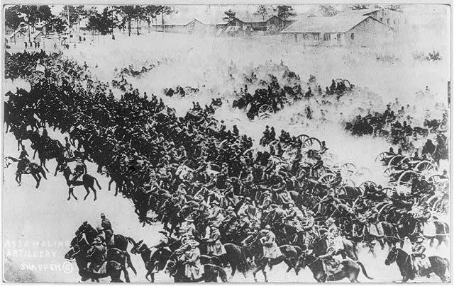 A mass of United States horse-drawn artillery advancing through dust during training around 1919